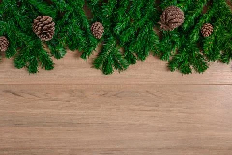 Fir branches and Pine cones on wooden board Stock Photos
