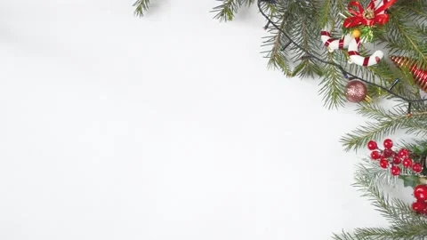 Fir branches with Christmas decorations and a garland on a white background. Stock Footage