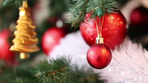 Fir branches decorated with red and golden xmas toys, white shining garland Stock Footage 96065447