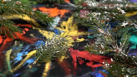 Fir branches sprinkled with silver glitter are on black pattern fabric Stock Footage 282538239