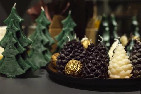 Fir Tree and Pine Cone Shaped Candles on the Table Stock Photos