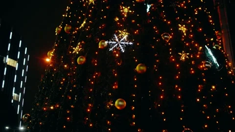 Fir tree beautifully decorated with silver lights, a modern building in the Stock Footage 145198978