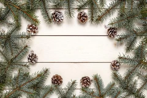 Fir tree branches and pine cones on wooden background Stock Photos