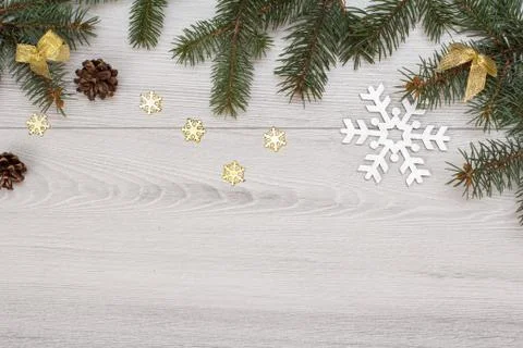 Fir tree branches with cones and decorative snowflakes on gray background Stock Photos
