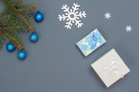 Fir tree branches with cones, gift boxes and decorative snowflakes Stock Photos