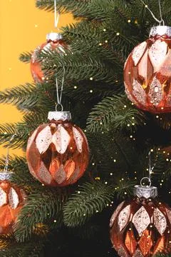 Fir tree with New Year decorations. Glowing gold Christmas ornaments. Stock Photos