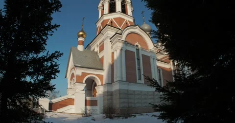 Fir trees against the sky, behind which the Orthodox Cathedral. Video stock 293946728