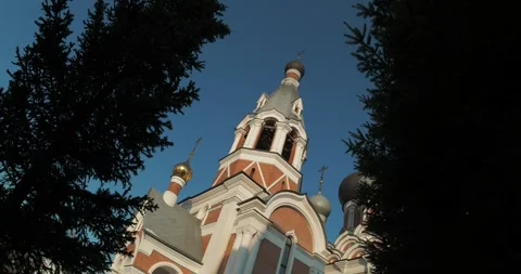 Fir trees against the sky, behind which the Orthodox Cathedral. Video stock 293946802