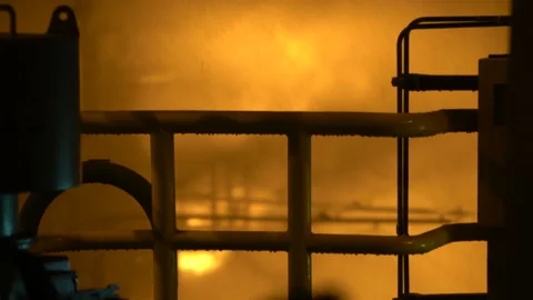 Fire. against the background of the railing on which water flows, flames are Stock Footage 137874925