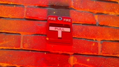 Fire alarm being pulled during a growing fire. Fire embers emitted from fire. 4K Stock Footage 201182438