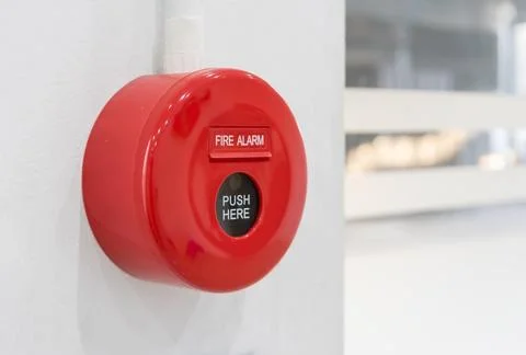 Fire alarm mounted on cement wall for warning and security system Stock Photos