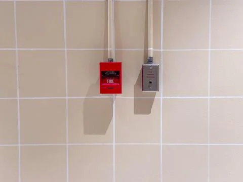 Fire alarm switch on the background of a tile wall,press the button to acti.. Stock Photos