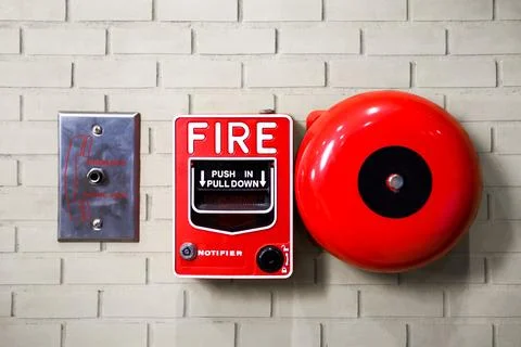 Fire alarm switch on brick wall texture background.... Stock Photos