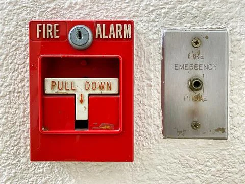 Fire alarm switch on cement wall for warning Stock Photos