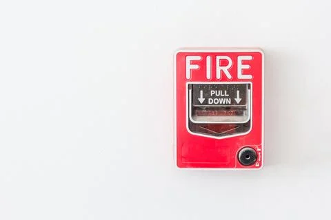 Fire alarm switch on white wall as background for warning and security system Stock Photos