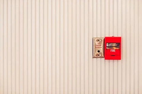 Fire alarm system box installed on wall in modern building. Stock Photos