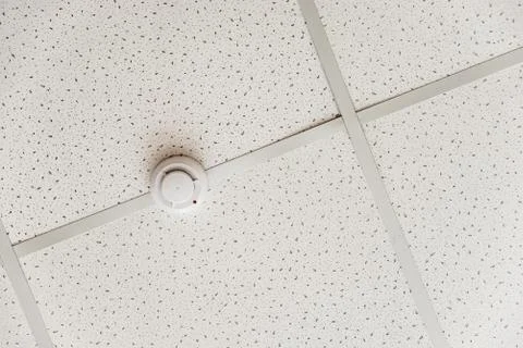 Fire alarm on a white ceiling Stock Photos