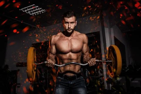 Fire and flame design. man in gym. Muscular bodybuilder guy doing exercises with Stock Photos