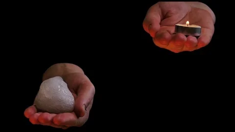 Fire and ice on balanced hands on black - abstract video Stock Footage 72905252