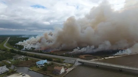 Fire and smoke near highway and houses Stock Footage