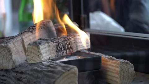 A fire in the artificial fireplace in the street cafe Stock Footage 83456199