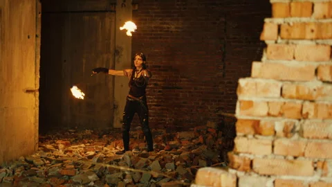 Fire artist performing with burning torches inside abandoned building Stock Footage 282967937
