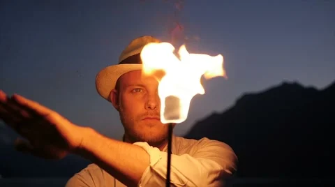 Fire artist presenting show with torchlight flame at night sky Stock Footage 42942390