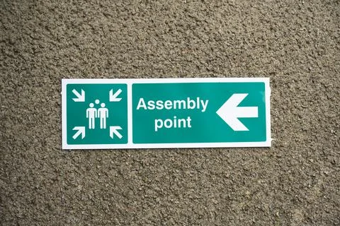 Fire assembly point sign at workplace signpost Stock Photos