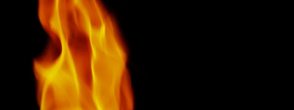 Fire background. Abstract burning flame and black background. Stock Photos