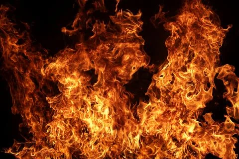 Fire background with bright blaze. Fire flame isolated on black. Fire textu.. Stock Photos