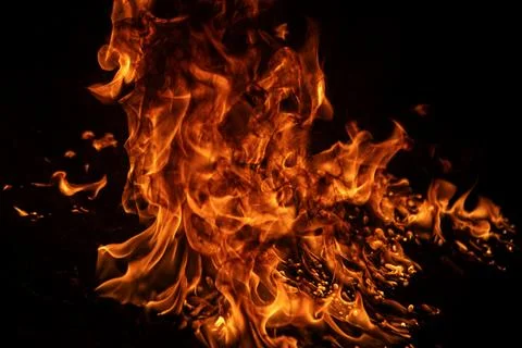 Fire background with glowing blaze. Fire flame burning on black. Fire texture Stock Photos