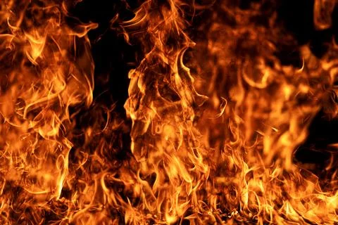 Fire background glows on black. Fire background creates hot texture. Burning Stock Photos