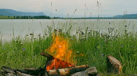 Fire in the background Lake and mountains Sayan. Primordial nature Stock Footage 41424160