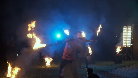 Fire Baton Show By Man. Guy Breathes Fire. In The Background Girl. Video stock 109452889