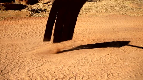 A fire beater is tested on a dusty patch of soil in a dry, rugged outdoor Stock Footage 284825221