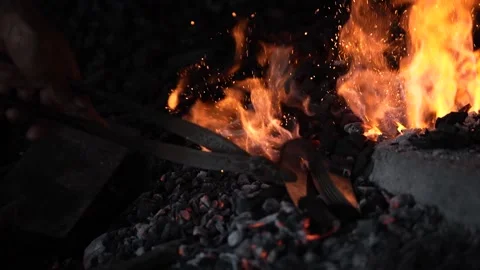 The fire in the blacksmith's fireplace was burning the sickle Stock Footage 262707586