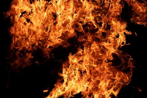 Fire blaze with orange flame. Fire burning on black background. Fire texture  Stock Photos