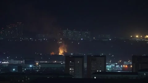 Fire bonfire over the roofs in the night city Stock Footage 276742197
