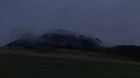 Fire breaks out at Arthurs Seat in Edinburgh during the evening Stock Footage 325850596