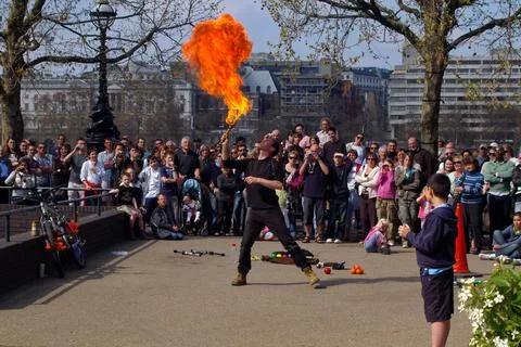 A Fire Breather Performs to crowd along the Southbank, London, UK. Stock Photos