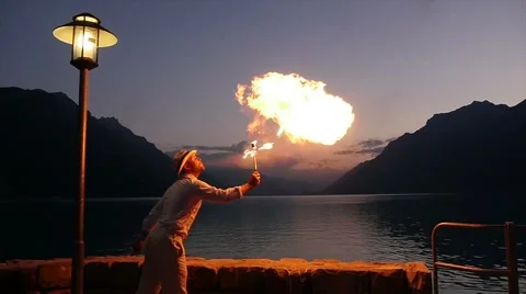 Fire breather spitting fire flame in slow motion at night sky Video stock 42941596