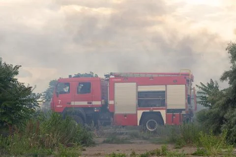 A fire brigade on a fire engine extinguishes a forest fire. Inscriptions on t Stock Photos