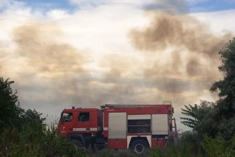 A fire brigade on a fire engine extinguishes a forest fire. Inscriptions on t Stock Photos