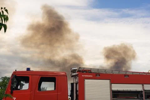A fire brigade on a fire engine extinguishes a forest fire. Inscriptions on t Stock Photos