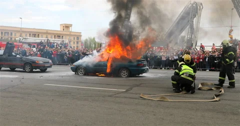 The fire brigade is preparing to extinguish the burning car Stock Footage 113766608