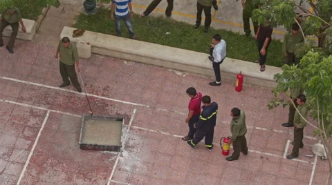 Fire Brigade Training Man Pours Petrol to Fire Model Plot Vídeos de archivo 65366534