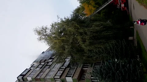 Fire in building, firefighters extinguish the fire on the balcony from the .. Stock Footage 256654888