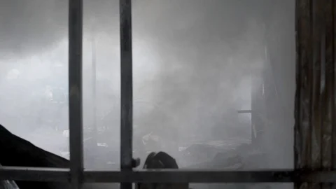Fire of building. Fireman extinguishes the fire with water. External market is Stock Footage 90092889