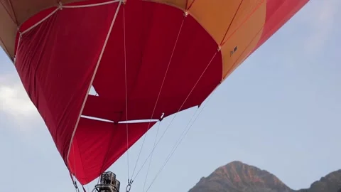 Fire from burner warming up air in huge balloon, filling up balloon with hot air Stock Footage 154064009