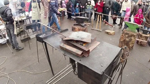 Fire Burning on a Background of Working Smiths in Apron Stock Footage 74793475